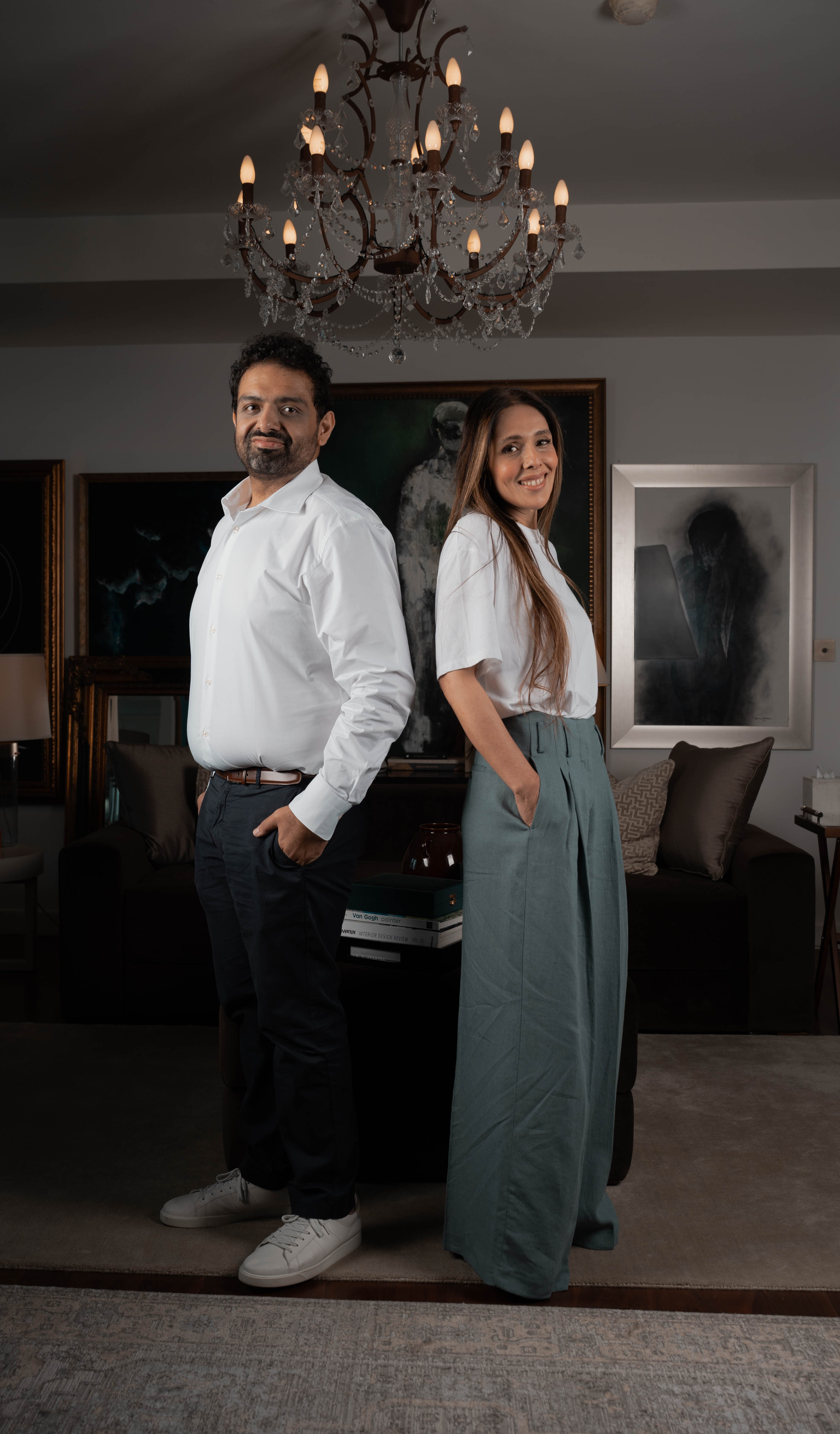 Bushra Khokhar and Tariq Ismail standing together beneath the chandelier in the studio